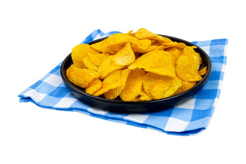 Black plate on a napkin with potato chips isolated on white