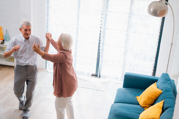 Celebrating Retirement: Elderly Couple Embrace Love and Happiness at Home, Fun-filled Life of Dancing, Smiling, and Bonding Together, Cherishing Family and Romance in Their Golden Years