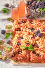 Tasty and fresh plum yeast cake with crumble and glaze.