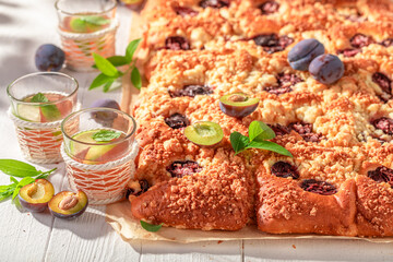 Sweet and delicious plum yeast cake served with lemonade.