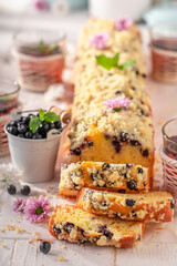 Closeup of sweet blueberries yeast cake served with lemonade.