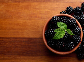black ripe blackberries on wooden tray blackberries close up