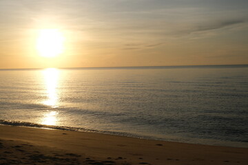 The sun rises at the sea in the morning.