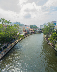 Aerial drone view of Malacca River with Malaysian settlements at Melaka, Malaysia.