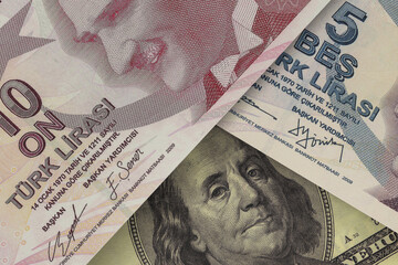 US $100 bill peeking out from under Turkish lira bills. Foreign exchange market. financial concept