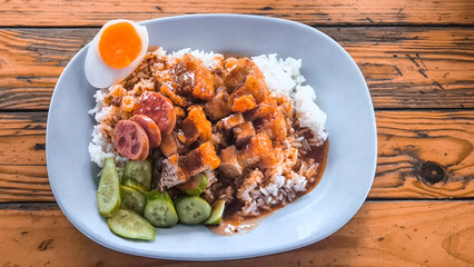 Crispy pork rice on a blue plate on the dining table
