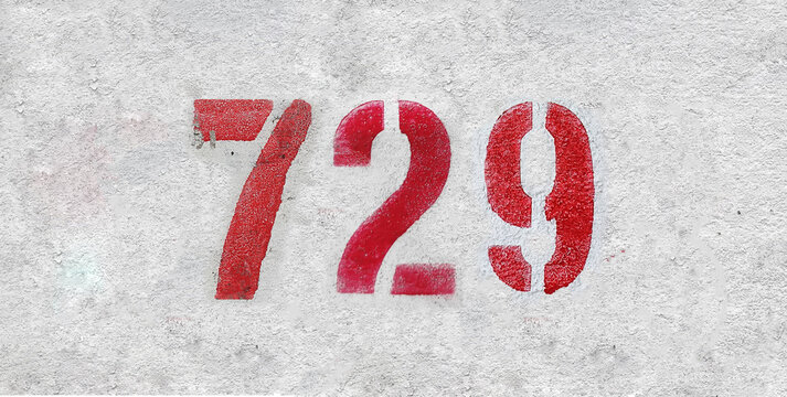 Red Number 729 on the white wall. Spray paint.