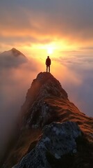 A lone figure standing on a mountain peak at sunset, surrounded by mist and breathtaking scenery, symbolizing solitude and adventure.