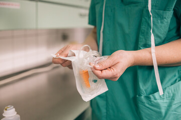 Medical staff member setting up an IV catheter for venous access