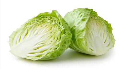 Fototapeta premium Crisp iceberg lettuce halved, showcasing its tightly packed, pale green layers. Isolated on a pristine white background