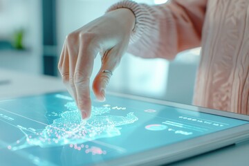 A woman's finger points at a digital map on a tablet screen, highlighting a specific location. The screen displays various data points and lines.