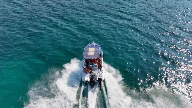 Aerial drone tracking video of  luxury inflatable rib speed boat cruising in mediterranean deep blue sea