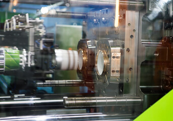 Process of plastic cups on plastic injection molding press machine. Industrial manufacturing