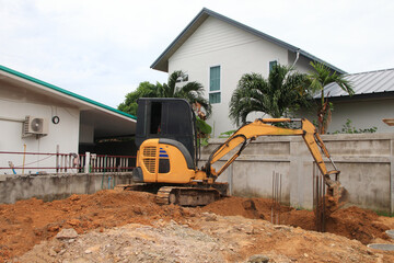 An excavator is digging soil in a construction site