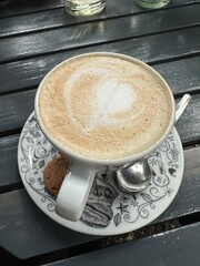 Cappuccino with foamy heart at cafe.