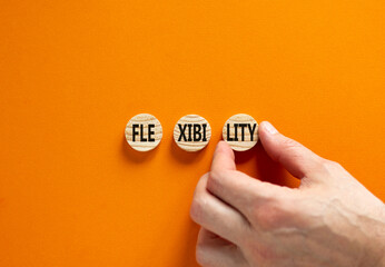 Flexibility symbol. Concept word Flexibility on beautiful wooden circles. Businessman hand....