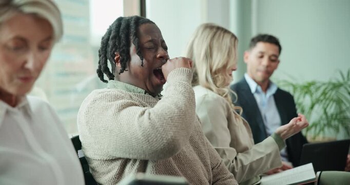 Group of people, office and man with yawning in recruitment as candidates, job opportunity and interview for diversity. Staff, tired male person and employees at company in hiring or human resources