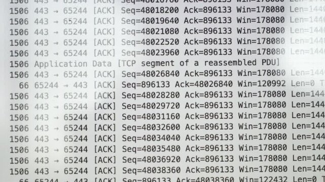 A laptop screen shows a lot of numbers and letters. The laptop is open to a page with a lot of information