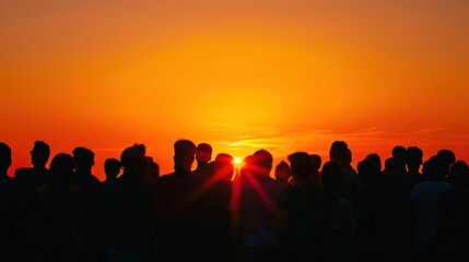 Fototapeta premium Silhouette of a crowd against a sunset.