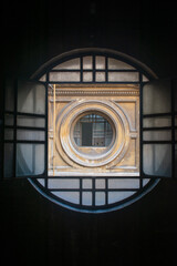 View from the dark. View from a circular window to another circular window. Photo composition.