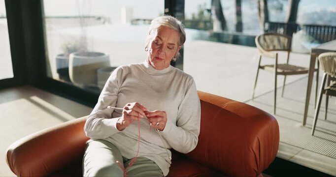 Senior woman, relax and knitting on sofa with retirement for jersey, organic fabric and skill in home. Elderly person, cotton wool and tools for handmade clothes with creativity, peace and hobby