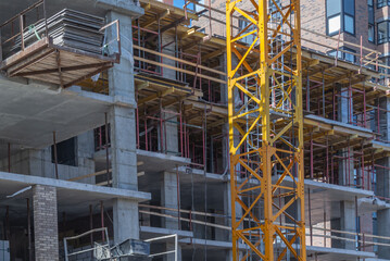 Reinforced concrete bearing supports of the frame of a high - rise building under construction.  Engineering technologies for the construction of multi-storey buildings.