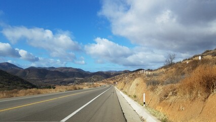road in the mountains leads through rolling hills to a destination unknown somewhere in mexico