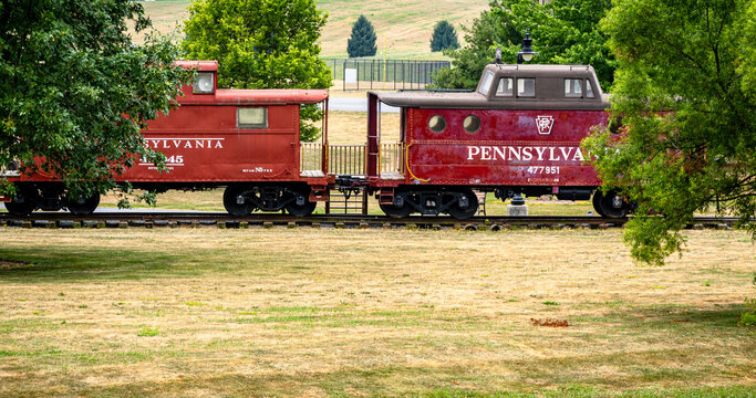 Chambersburg Pennsylvania USA 7-22-2024 Pennsylvania railroad red 1942 cabin car and 1916 unmodified caboose built at Altoona car shops and displayed at Norlo park outdoors