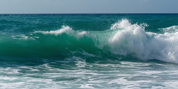 Emerald Fury: A powerful ocean wave, vibrant green in the sunlight, crests and crashes towards the shore in a mesmerizing display of nature's power. 