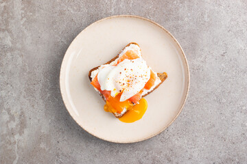 Poached egg on salmon and cheese toast. Breakfast food concept. Open sandwich. 