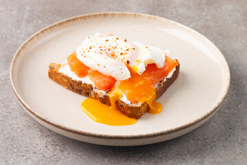 Poached egg on salmon and cheese toast. Breakfast food concept. Open sandwich. 