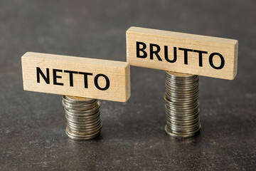 Netto and brutto. Net and gross symbol. Words on wooden cubes set on smaller and larger stack of...