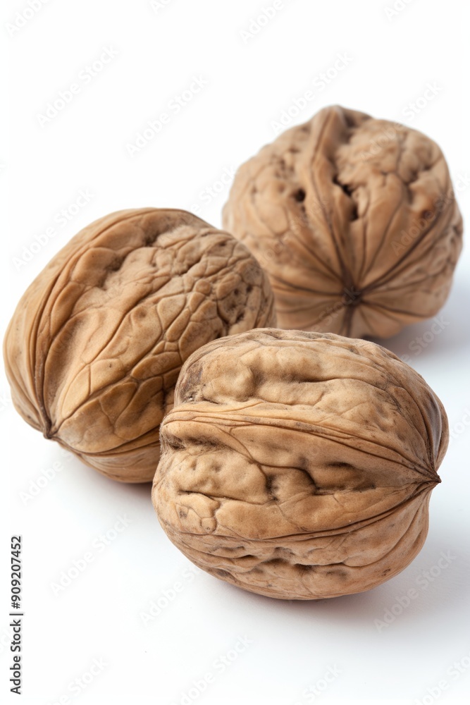 Poster three walnuts are shown on a white background. they are all different sizes and have a wrinkled text