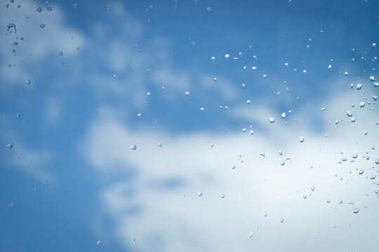Drops of rain against a blue sky after a summer storm