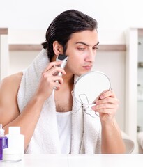 Young handsome man in the bathroom