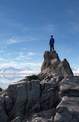 Adventure Man Hiker high in mountains. Landscape in Background.