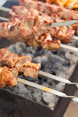 Skewered meat cooks perfectly over hot charcoal, making it ideal for summer barbecues and social gatherings