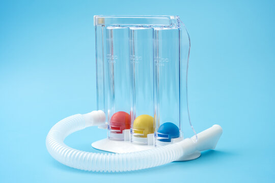 Medical Incentive Spirometer with Colorful Measurement Balls on Blue Background Concept for Respiratory Health, Pulmonary Rehabilitation, and Breathing Exercise Tools