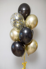 black and gold balloons on white background