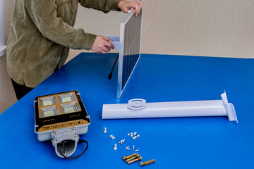 Solar panel and LED outdoors light will be fixed on mounting bracket before being installed on...