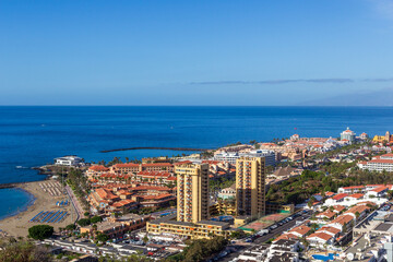 Naklejka premium Panorama of hotels and Atlantic Ocean holiday resort Playa de las Americas on Canary Island Tenerife, Spain