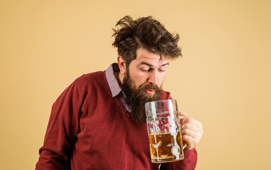 Leisure and beer time. Drunk bearded man tasting fresh brewed beer. Oktoberfest festival. Brewer with glass of craft beer. Germany traditions. Alcohol. Handsome male drinking draft beer in bar or pub.