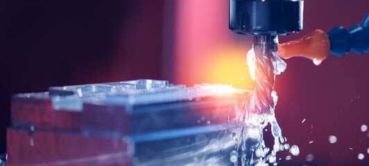 Closeup CNC milling machine during operation. Produced cutting metal parts, banner background of...