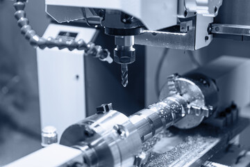 CNC turning production of shafts for cars factory. Concept machine for cut metal industry, blue...