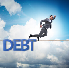 Debt and loan concept with businessman walking on tight rope