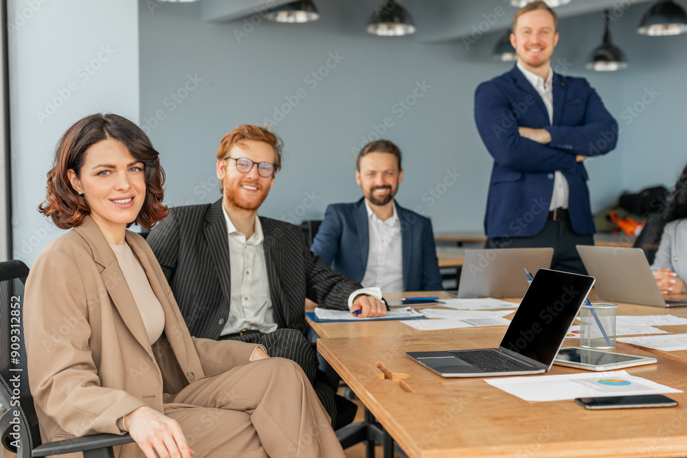 Aufkleber a diverse team of four professionals sits around a conference table in a modern office space. they a