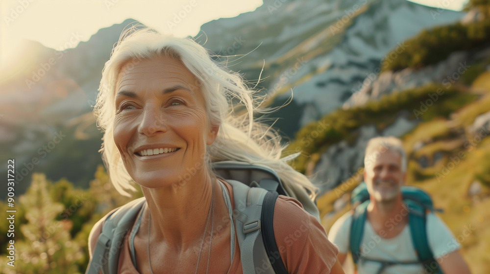 Canvas Prints happy mid-aged women and man hiking in the mountains. a full-body shot shows them walking up a mount