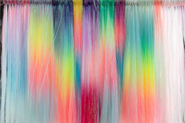 Psychedelic multicolored background abstract. Rainbow colors. patterns background. Photo macro shot of pastel colored synthetic hair.