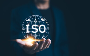 ISO Standards and Quality Assurance Concept. Businessman presenting globe with various ISO icons...
