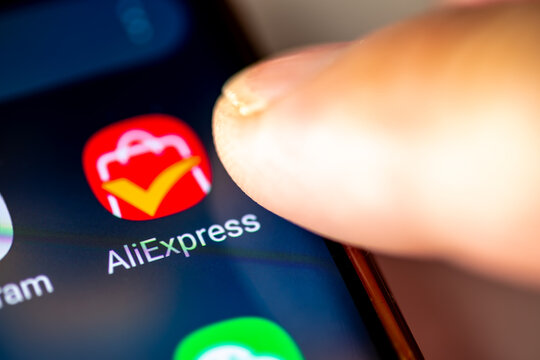 London. UK- 07.28.2024. The online retail service app AliExpress on the screen of an Android phone with a finger opening the application.